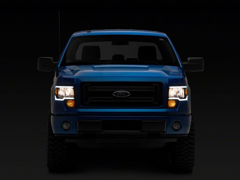 Phares Raxiom 09-14 Ford F-150 série axiale avec barre LED - boîtier noir (lentille transparente)