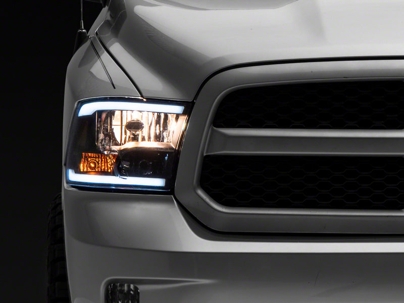 Raxiom 09-18 Dodge RAM 1500/2500/3500 Axial Series Headlights w/ LED Bar- Blk Housing (Clear Lens)