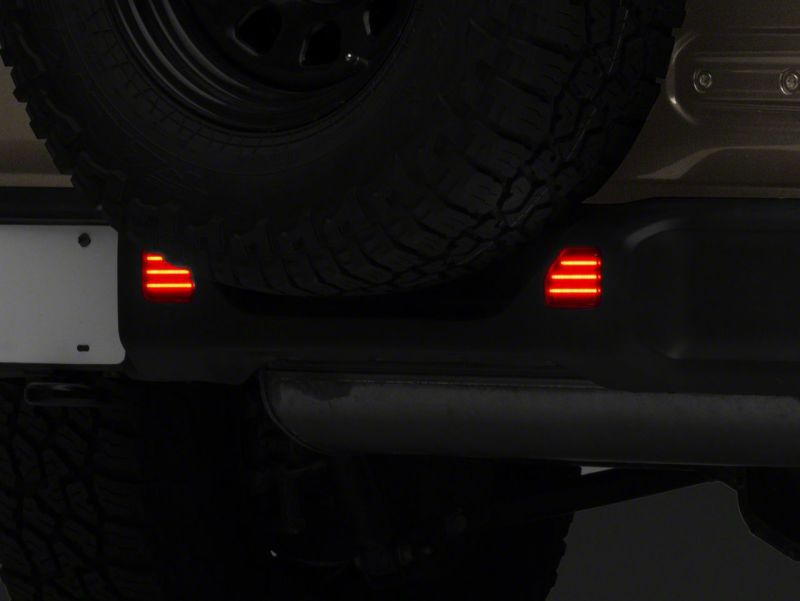 Raxiom 18-23 Jeep Wrangler JL Moab Rubicon Sahara Axial LED Rear Bumper Reflector Lights- Smoked