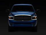 Raxiom 06-09 Dodge RAM 1500/2500/3500 Axial Headlights w/ SEQL LED Bar- Blk Housing (Clear Lens)
