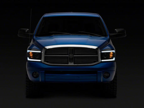 Raxiom 06-09 Dodge RAM 1500/2500/3500 Axial Headlights w/ SEQL LED Bar- Blk Housing (Clear Lens)