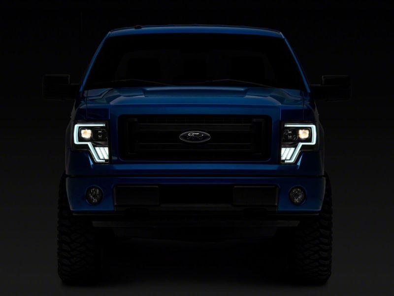 Raxiom 09-14 Ford F-150 Axial G4 Light Bar Switchback Projector Headlights- Blk Housing (Clear Lens)